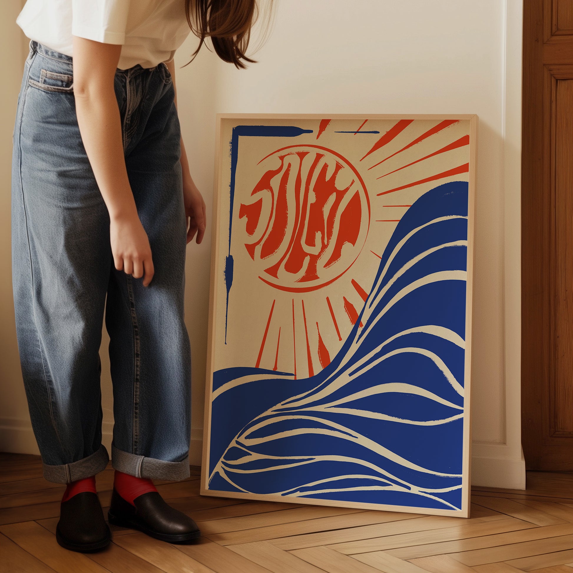 a woman standing next to a painting on a wooden floor