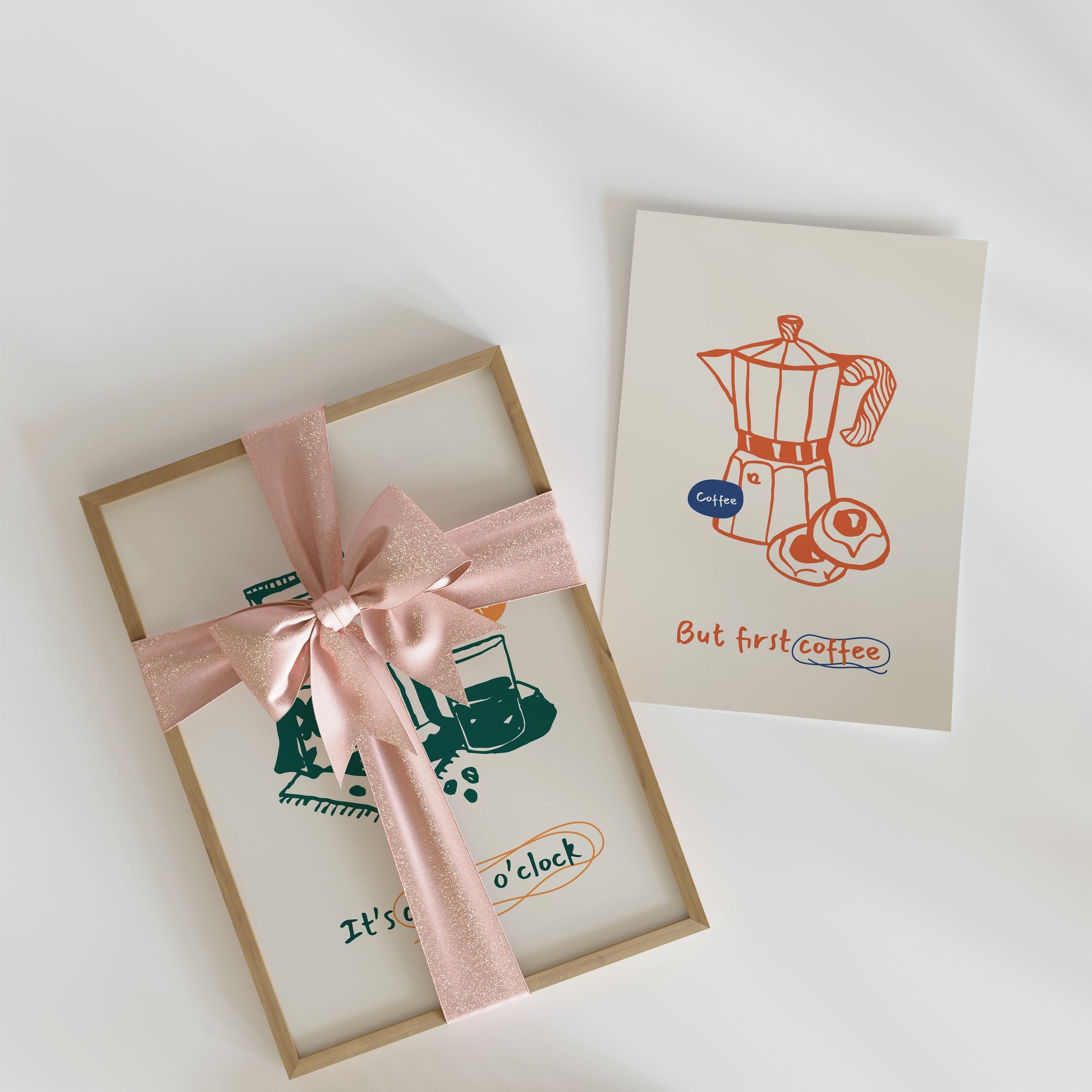a gift box with a pink ribbon and a card with a picture of a coffee