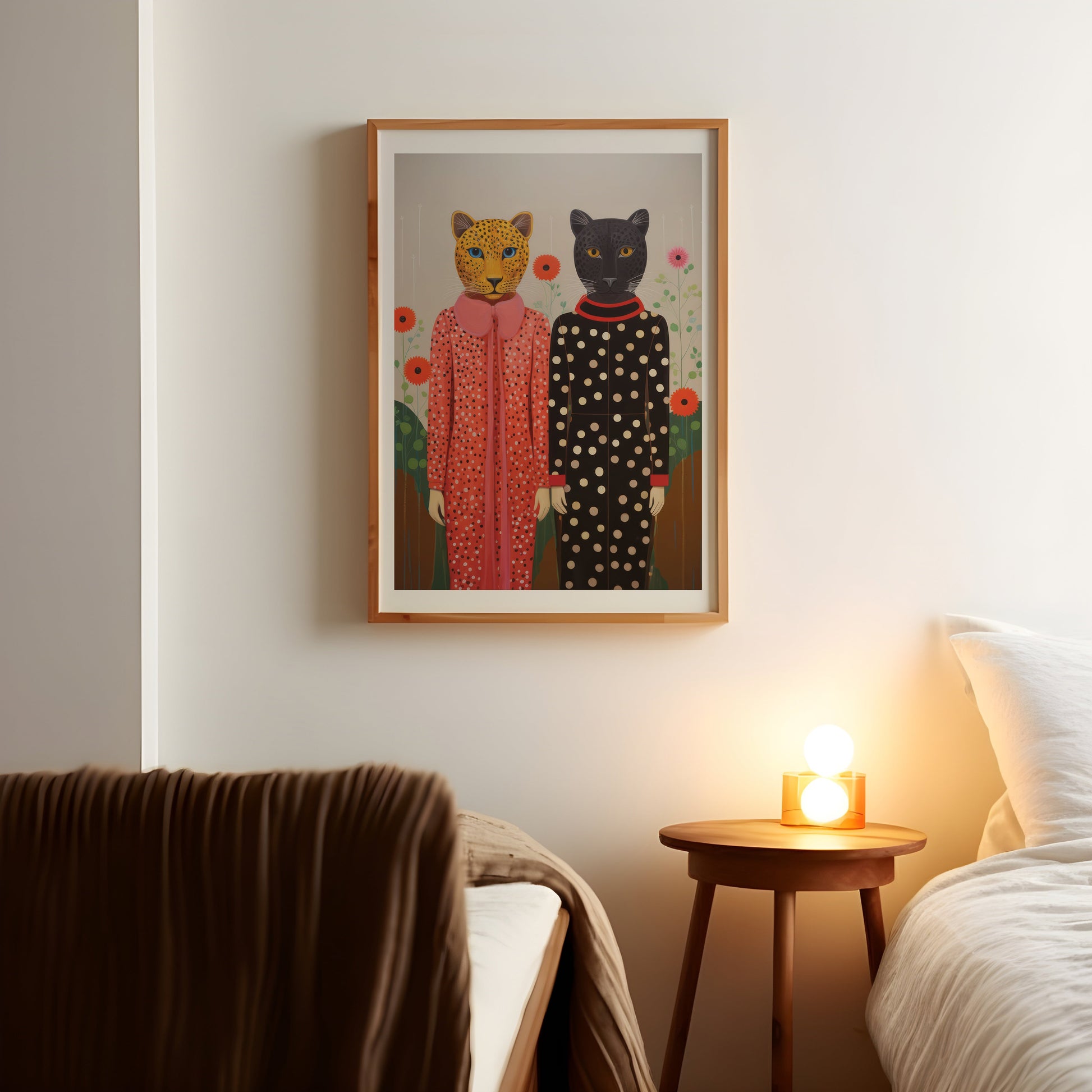 a picture of two cats on a wall above a bed