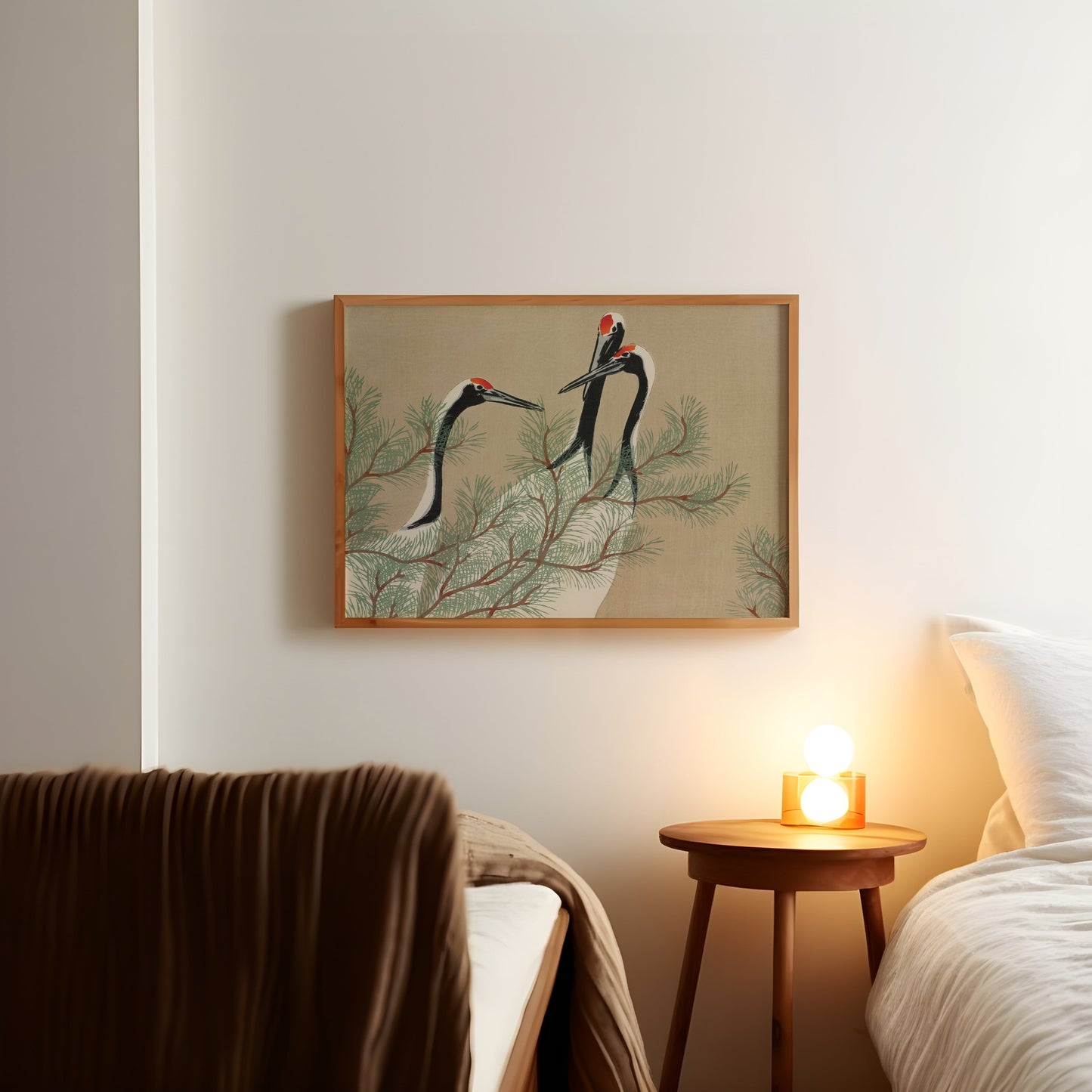 a picture of two birds on a wall above a bed