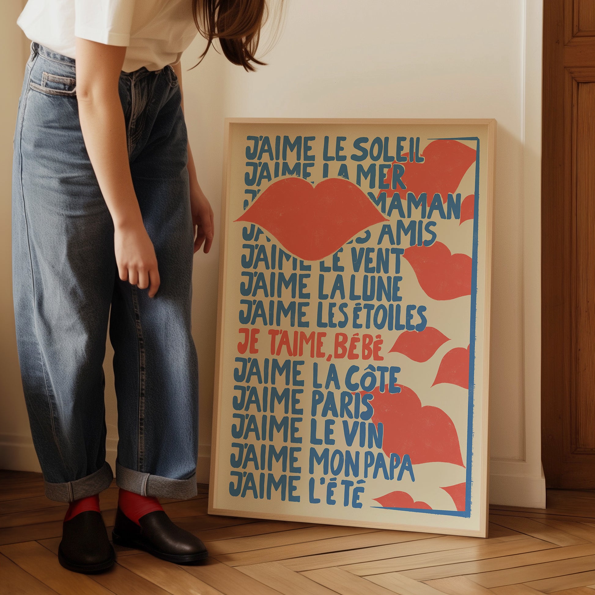 a woman standing next to a poster on a wooden floor