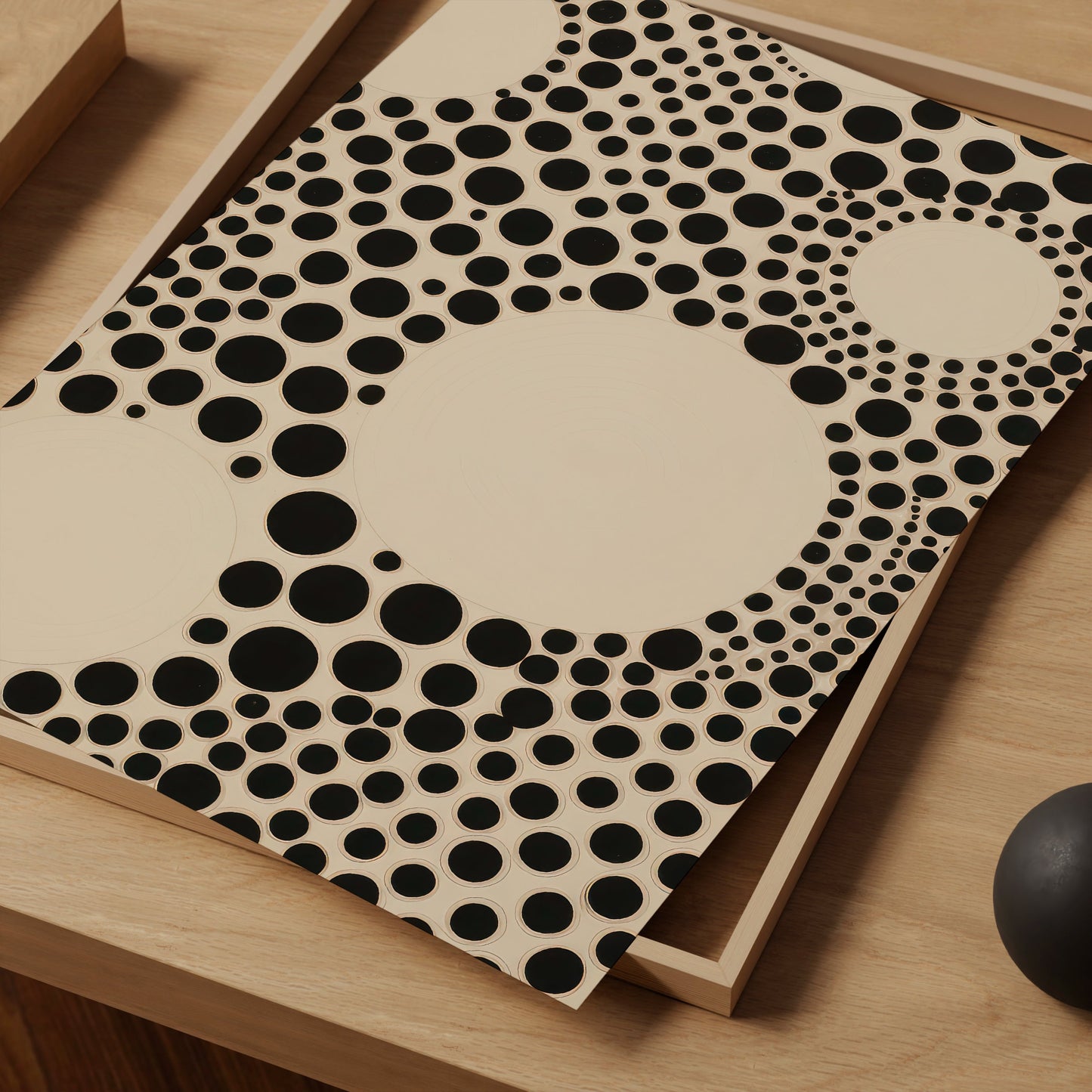 a wooden table topped with a black and white polka dot design