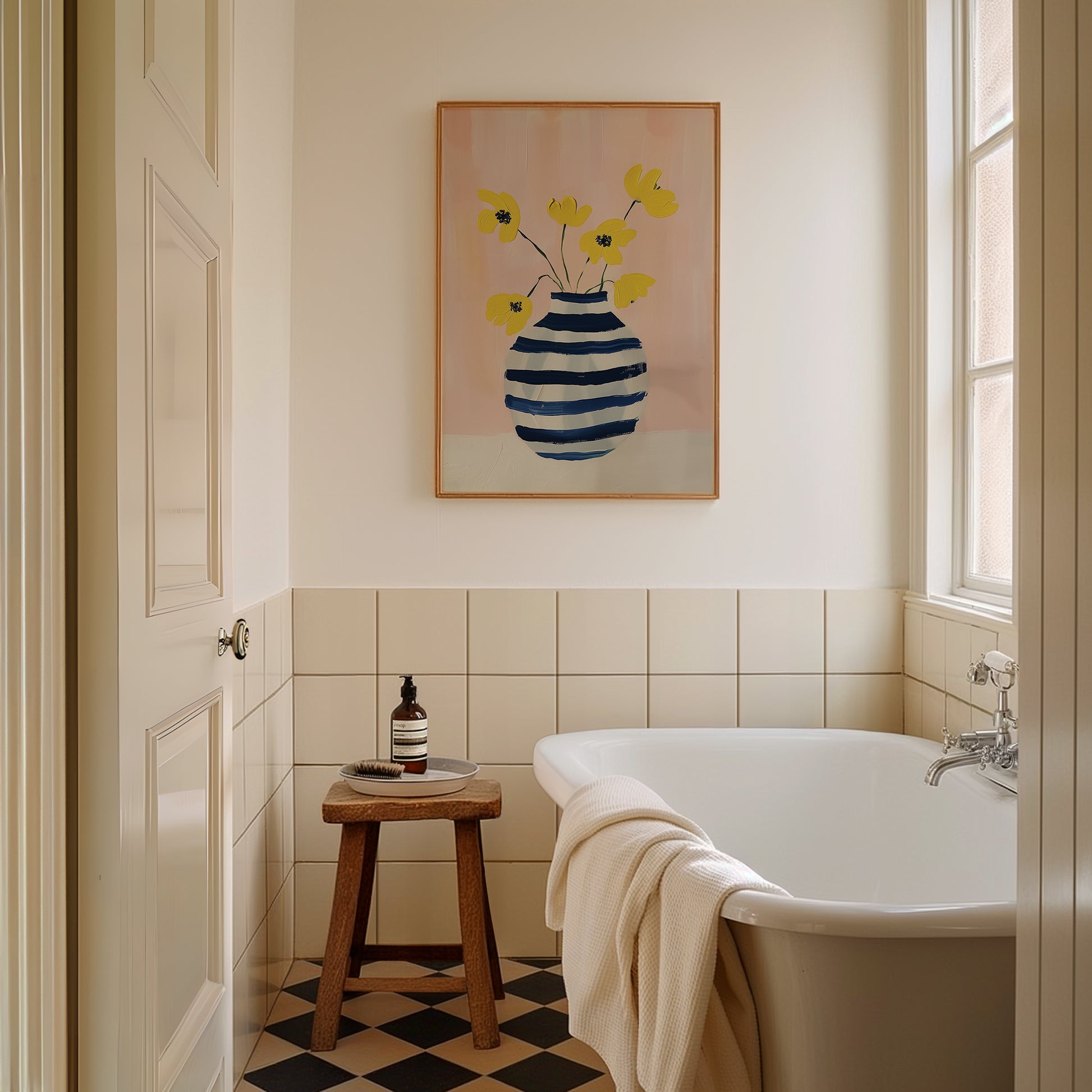 a bathroom with a checkered floor and a painting on the wall