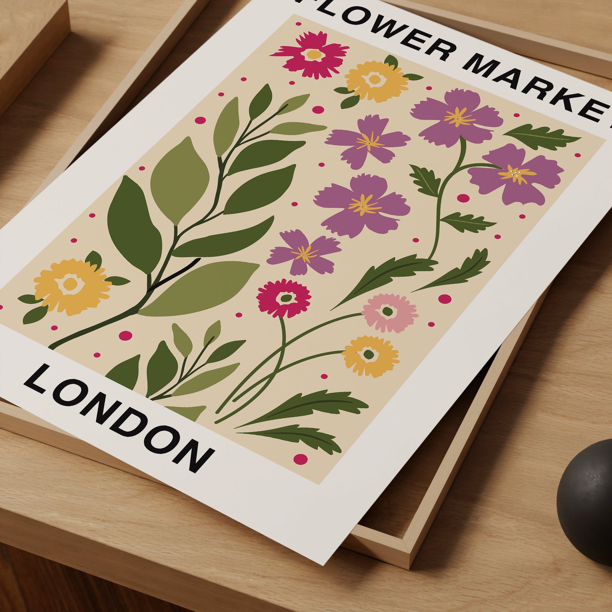 a picture of a flower make london poster on a desk