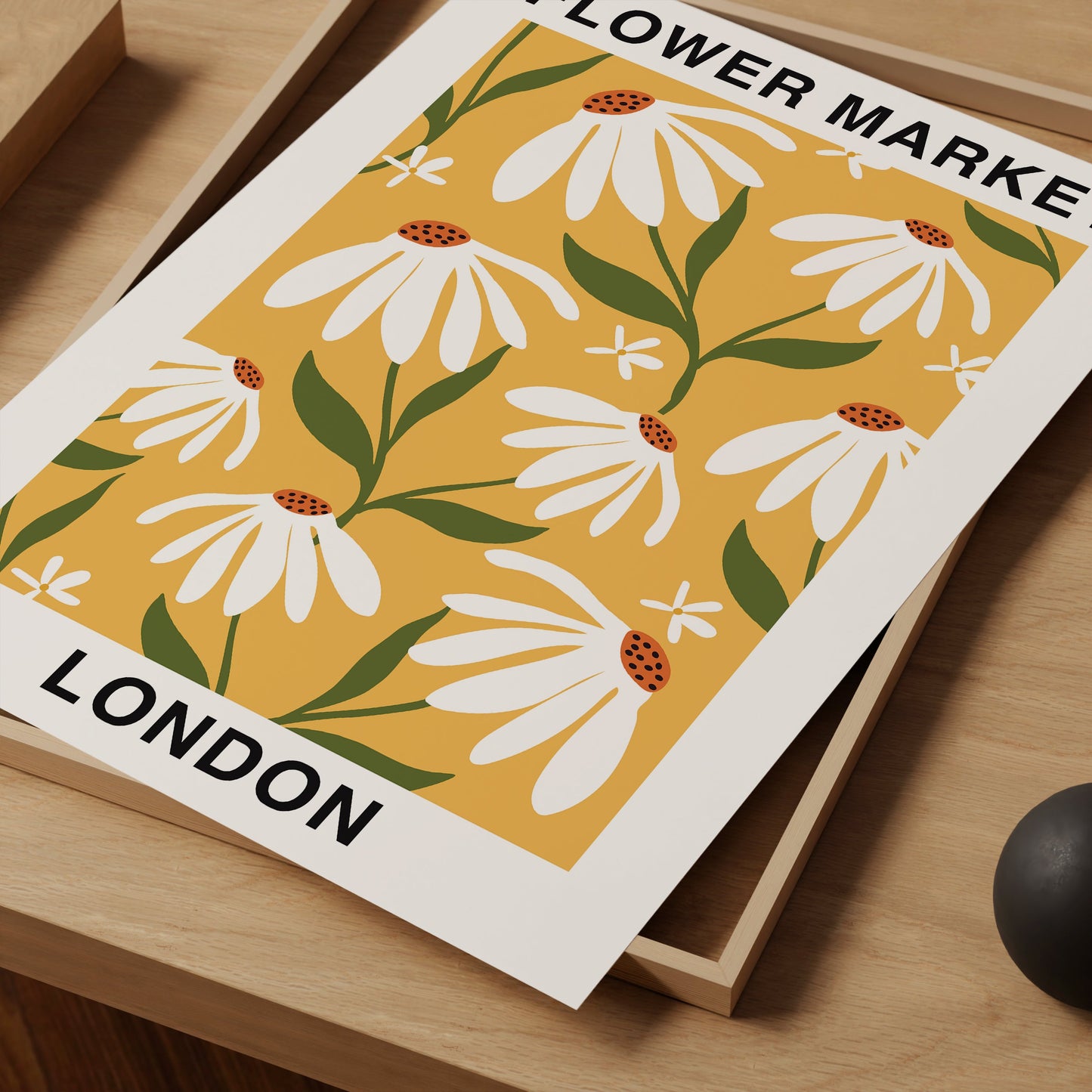 a flower make london poster sitting on a desk