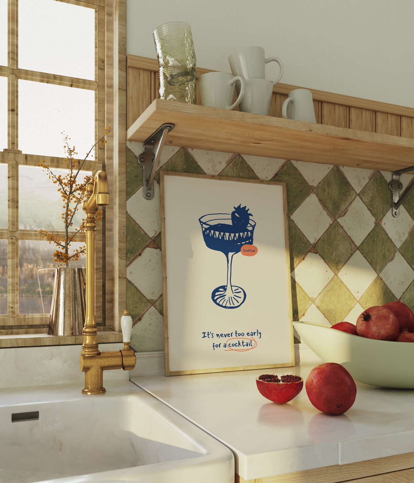 a kitchen counter with a bowl of apples and a framed poster