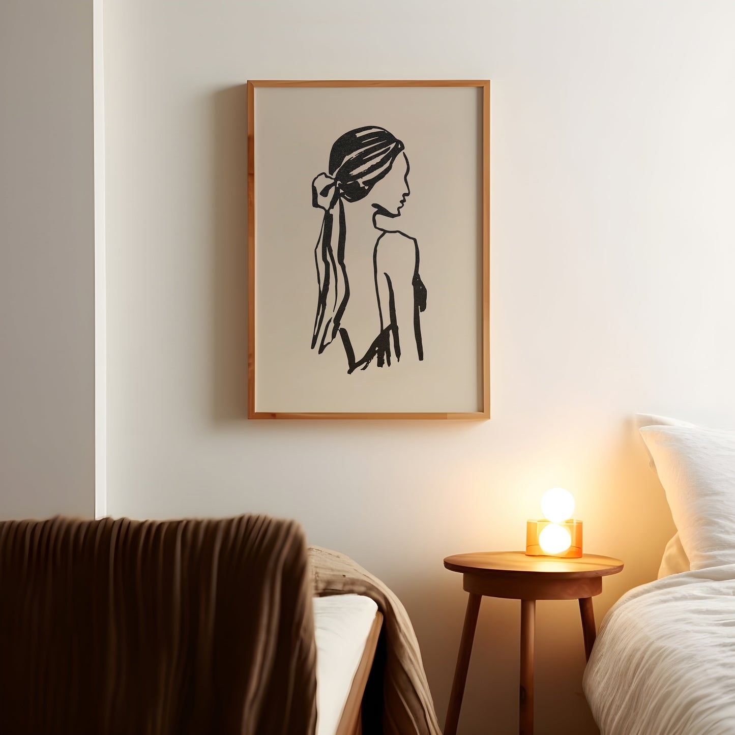a picture of a woman's head on a wall above a bed
