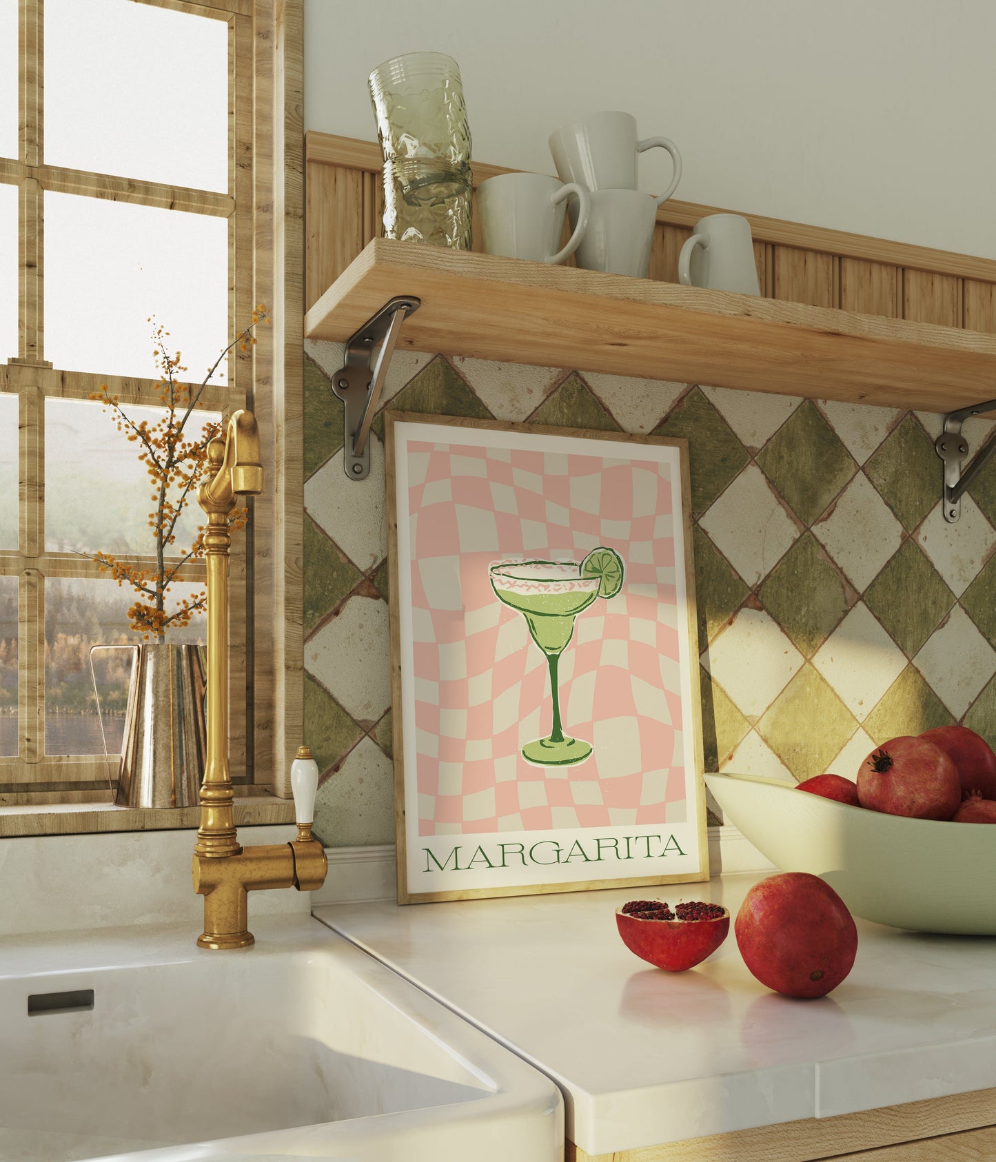 a kitchen counter with a bowl of apples and a poster