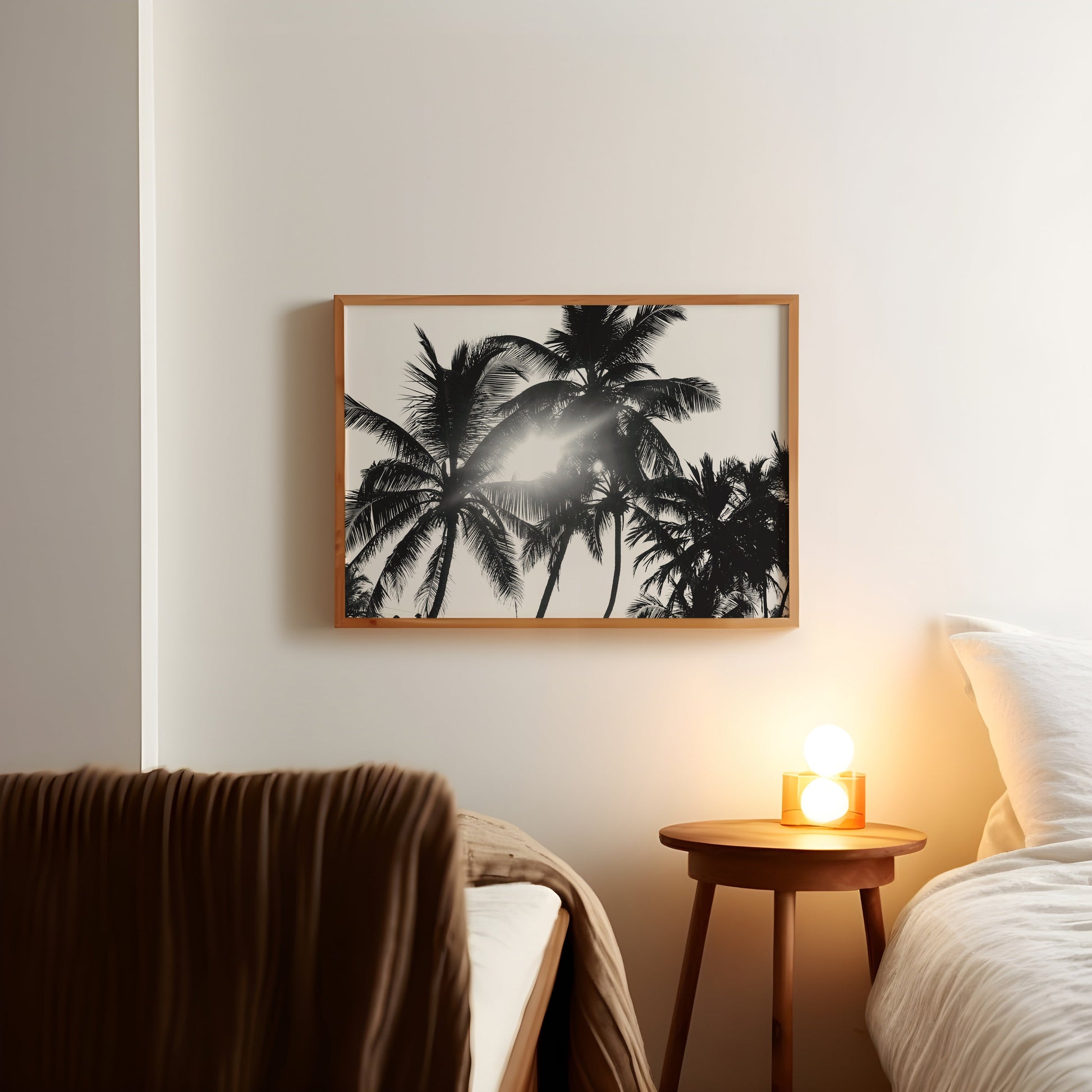 a picture of a palm tree hangs above a bed