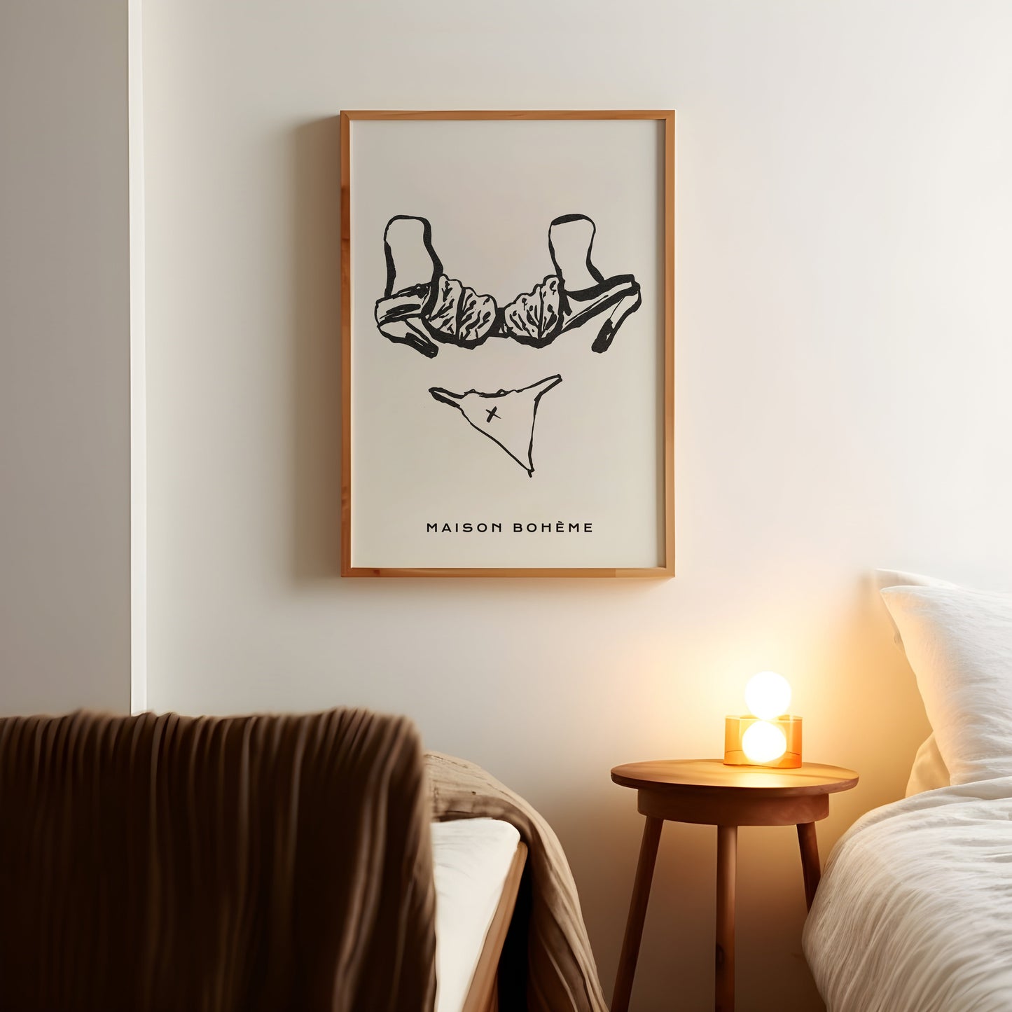 a bedroom with a bed and a picture hanging on the wall