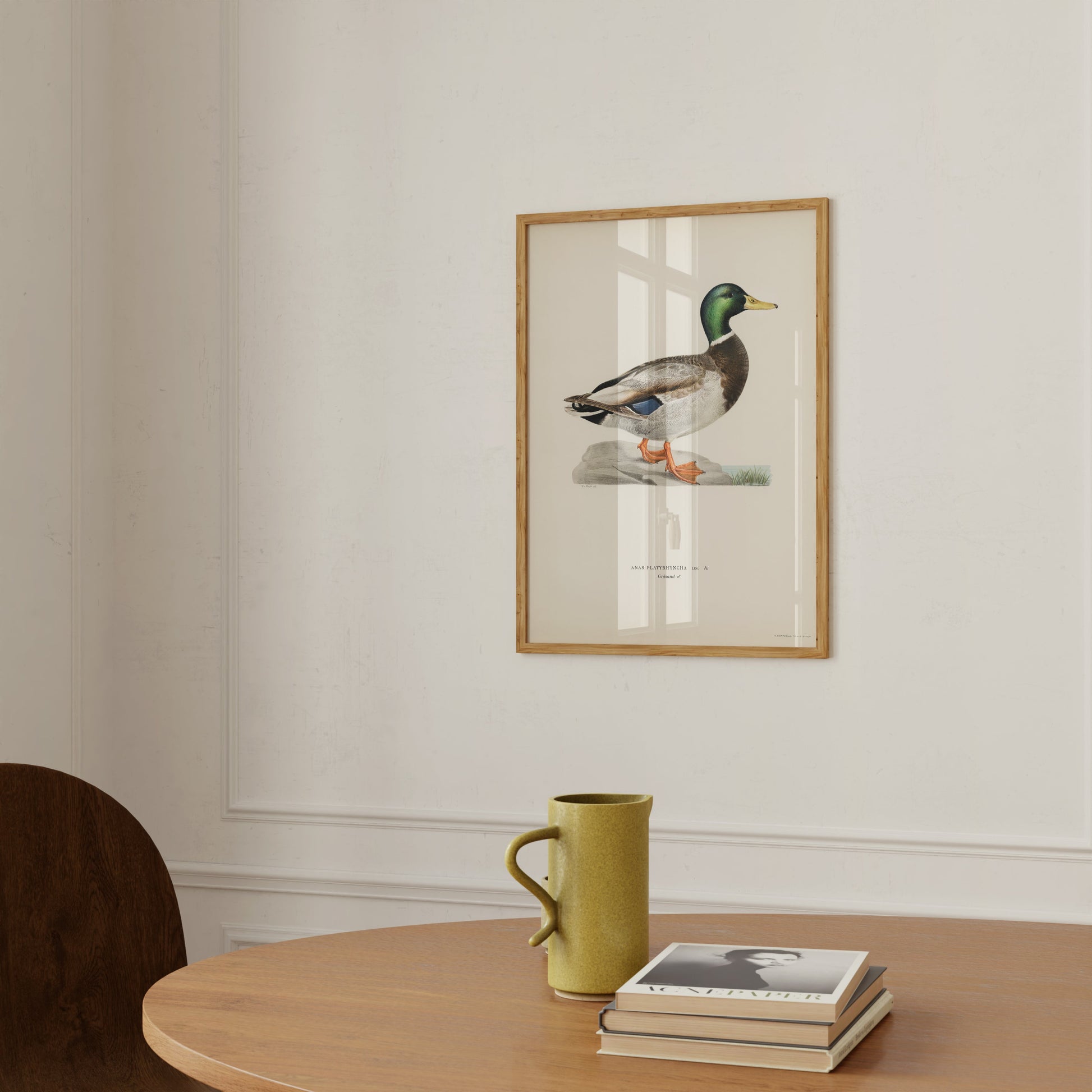 a picture of a duck on a wall above a table