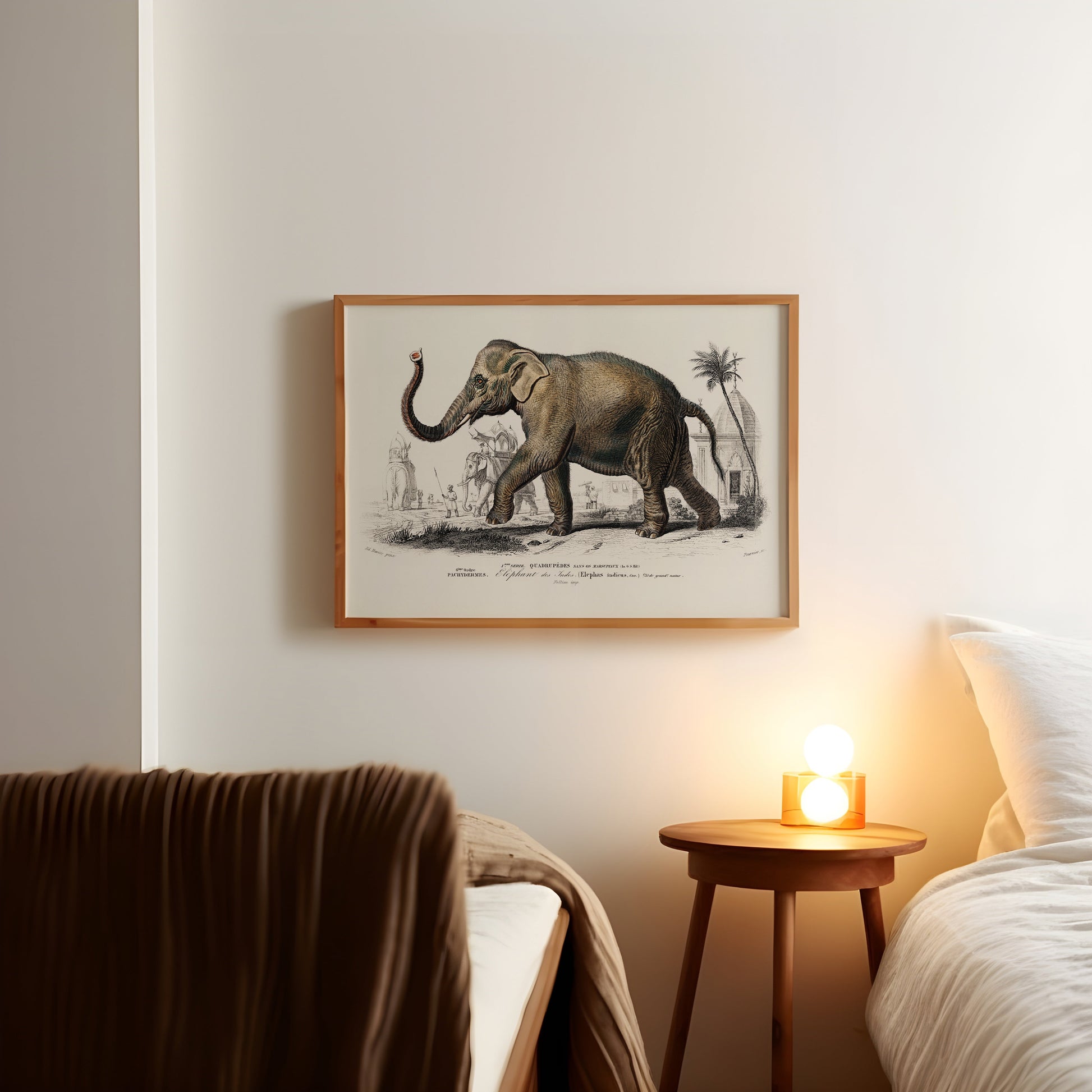 a picture of an elephant on a wall above a bed