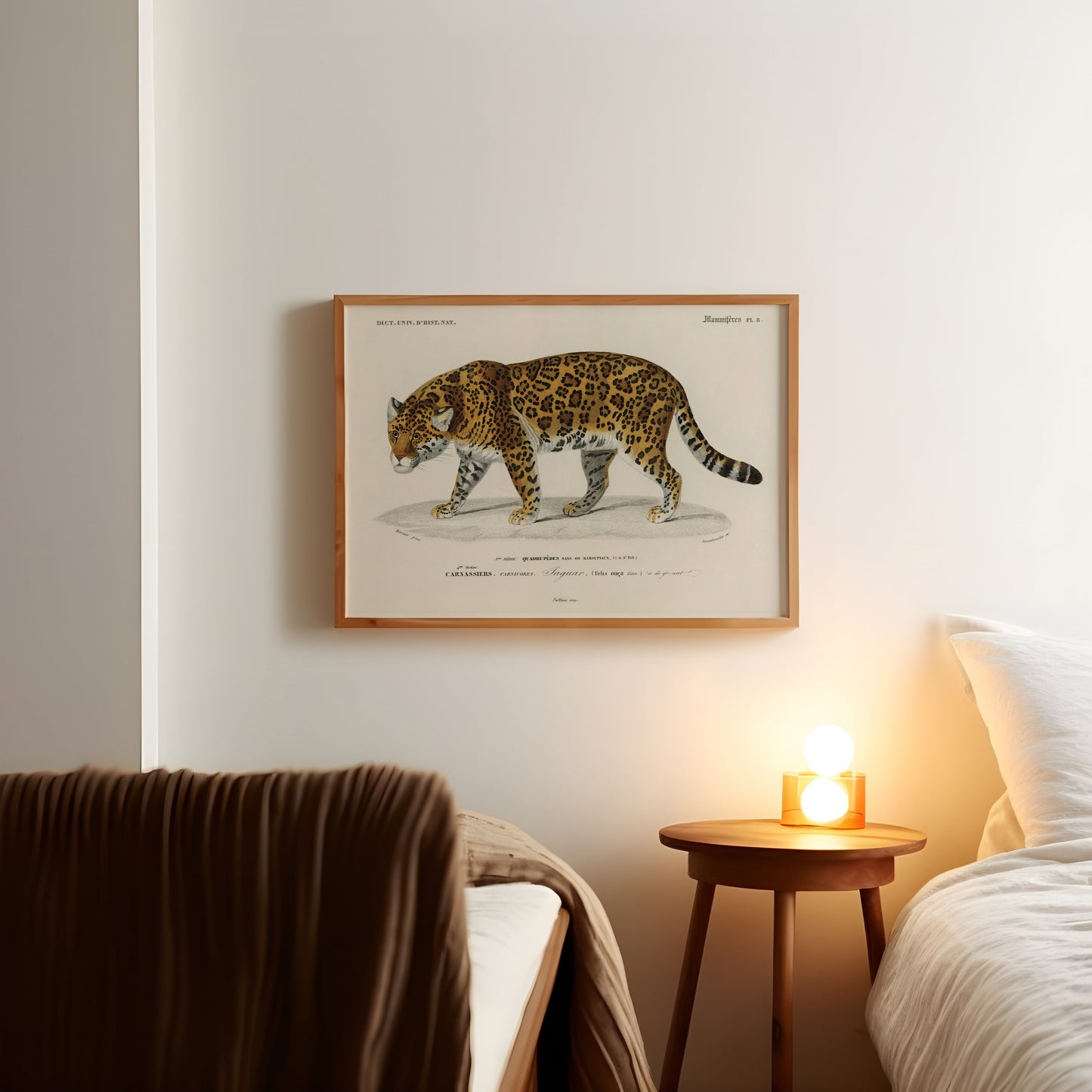 a picture of a cat on a wall above a bed