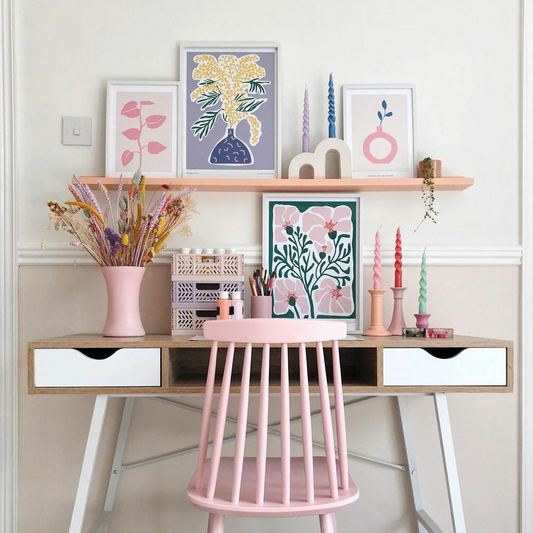 a desk with a pink chair next to it