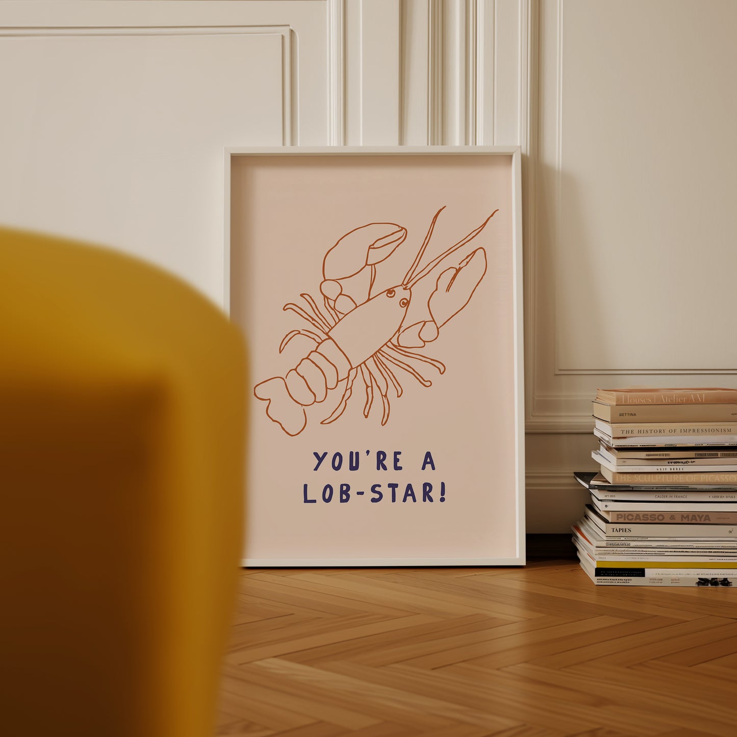 a picture of a lobster on a table next to a stack of books